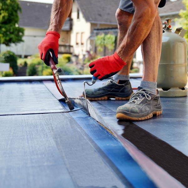 Roofing workers safely install new shingles on a sunny day in Port Orchard, Olympia & Aberdeen