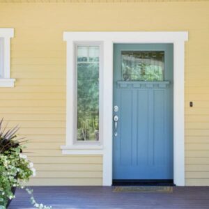blue front door and yellow siding